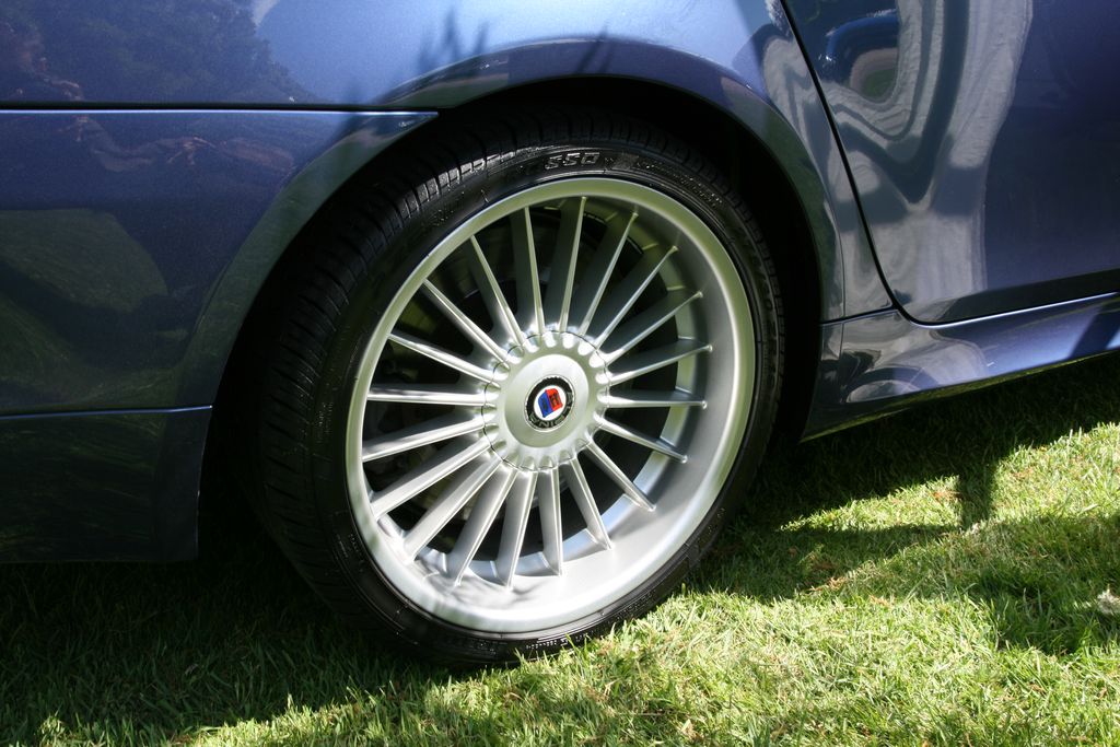 Close-up of a clean silver multi-spoke alloy wheel and tire on a car