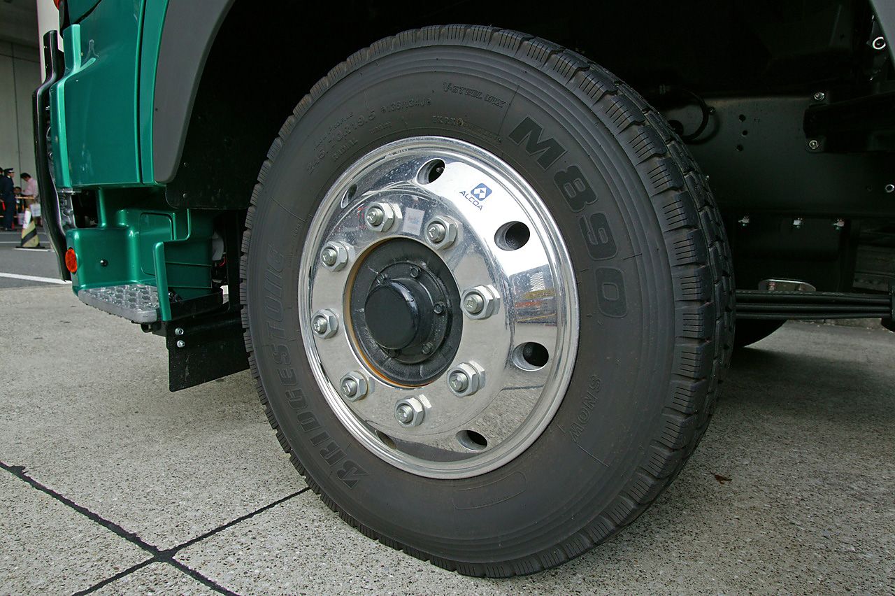 Polished aluminium truck wheel and tire mounted on a heavy-duty vehicle